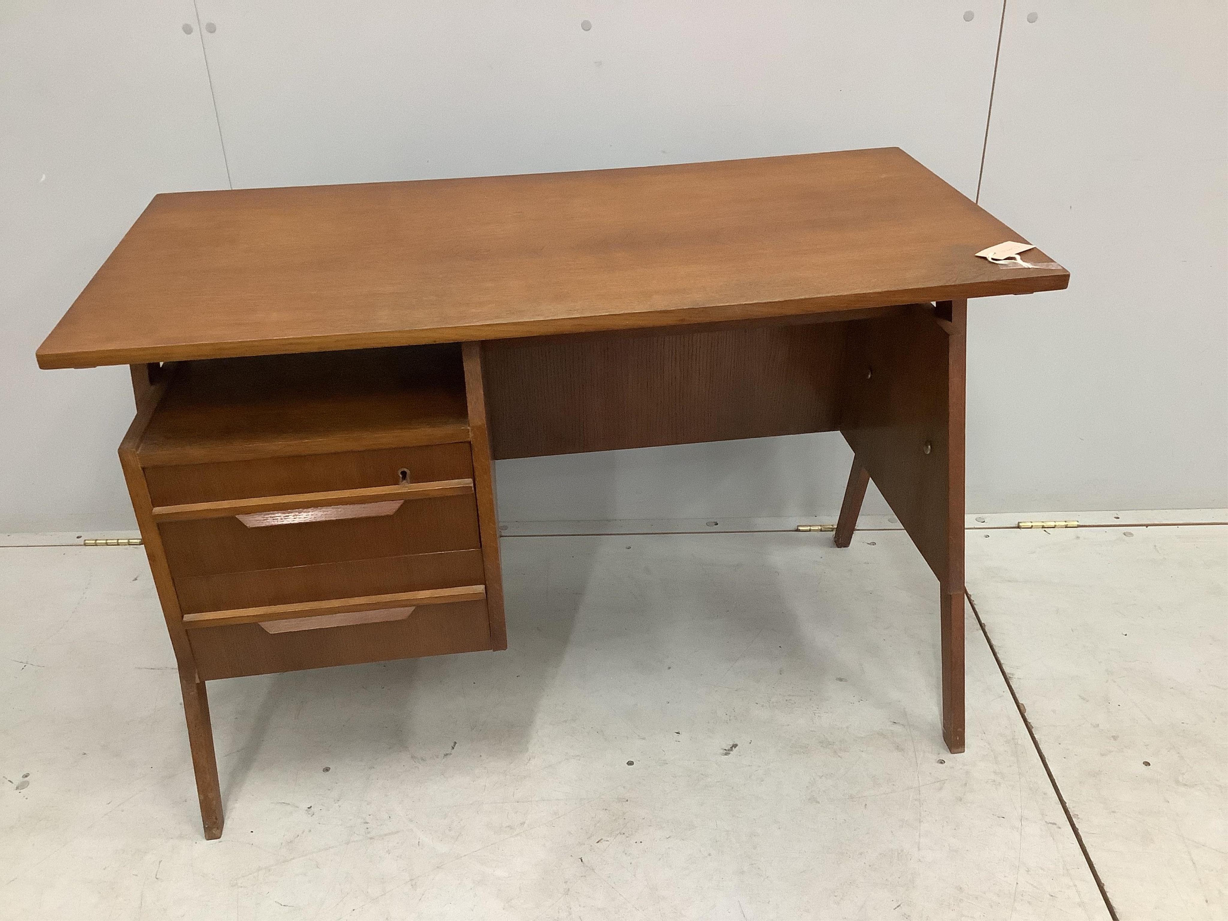 In the manner of Robin Day, a 'Hillstak' type oak desk, width 110cm, depth 55cm, height 71cm. Condition - fair